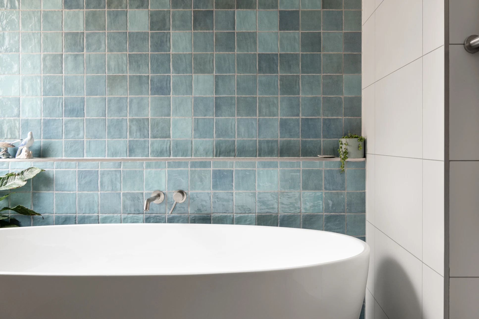 Salle de bain moderne avec douche à l'italienne, vasque suspendue en pierre naturelle, radiateur sèche-serviettes